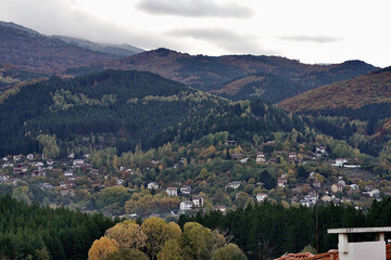 Beautiful landscape with mountains and a town bellow on a cloudy day