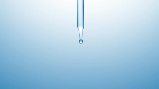 Macro shot of clear drops are falling down from chemical dropper on pale blue background | Abstract skincare lotion ingredients formulation concept