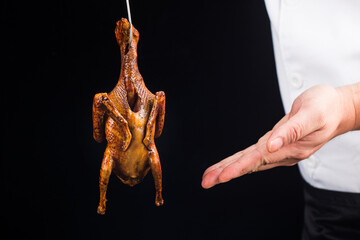 Traditional Cantonese roast pigeon on a and white porcelain plate