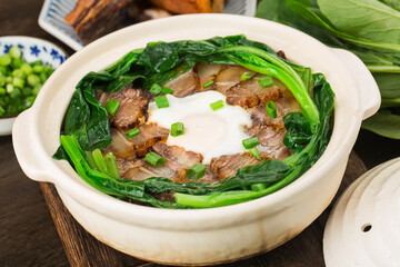 Cantonese style cooking of claypot rice with waxed meats