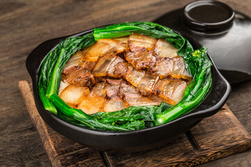 Cantonese style cooking of claypot rice with waxed meats