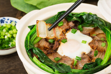 Cantonese style cooking of claypot rice with waxed meats