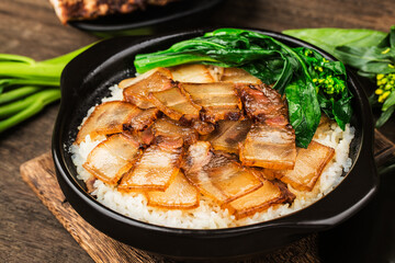 Cantonese style cooking of claypot rice with waxed meats