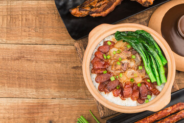 Cantonese style cooking of claypot rice with waxed meats