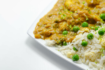 Chicken curry with egg fried rice, chicken breast pieces in a mildly spiced coconut curry sauce with fried rice with peas and egg