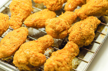 Southern crispy battered fried chicken wings, deep-fried chicken wings on the metal tray - 475877372