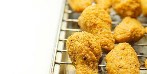 Southern crispy battered fried chicken wings, deep-fried chicken wings on the metal tray