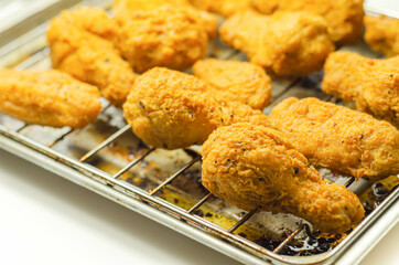 Southern crispy battered fried chicken wings, deep-fried chicken wings on the metal tray