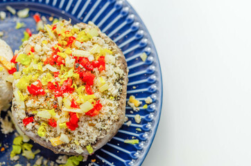 Mushrooms stuffed with onion, garlic, leek, paprika and sprinkled with cheese and breadcrumbs, snack prepared for baking