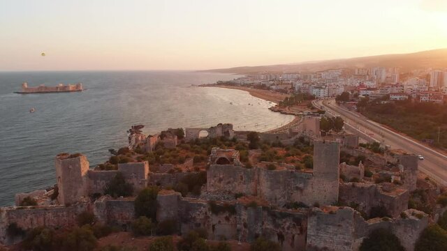Aerial zoom out view sunset over Maiden's Castle Kiz kalesi , Mersin city -Turkey