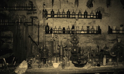 Old scary laboratory mining tools & measuring devices. Bottles in old pharmacy laboratory. Old vintage mini laboratory. Medieval drugs potion on dirty shelf, apothecary cabinet in pharmacy lab or shop