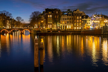 Fototapeta premium City scenic from Amsterdam at the river Amstel in the Netherlands at sunset