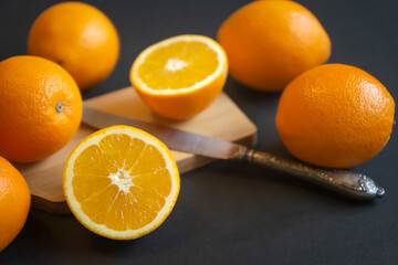 Orange fruit with green leaves on the wood. Home gardening. Mandarine oranges. Tangerine oranges. Orange color. Fresh orange juice.