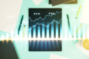 Multi exposure of abstract financial diagram and modern digital tablet on background, banking and accounting concept