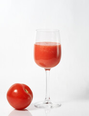 freshly squeezed tomato juice in a glass and tomato
