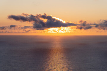 The view to sunset on ocean from mountain