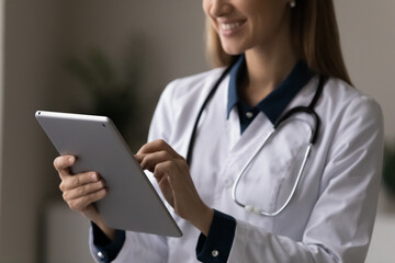 Digital medicine. Close up of happy female attending physician making electronic prescription on touchpad doing medical records online set appointment with patient. Doc consult client in chat remotely - obrazy, fototapety, plakaty