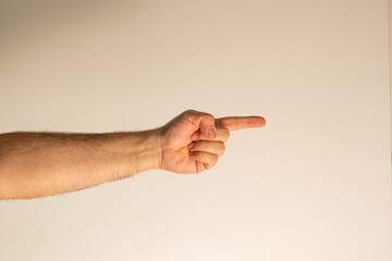 A gesture indicating a specific person or a specific thing. The index finger is extended forward and points in the right direction.