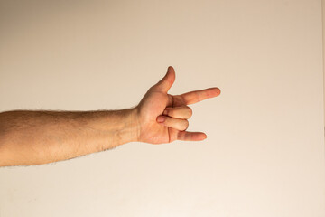 The gesture of heavy metal fans is a goat. The thumb, index finger and little finger are protruding...