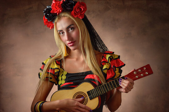 Gypsy woman wearing a traditional dress and playing charango