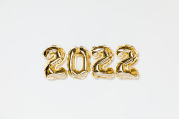 New year 2022 balloon celebration card. Gold foil helium balloon number 2022 isolated on white background. Flat lay, merry christmas, happy holidays mockup.