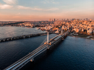  Drone shot of the Golden Horn Bridge in Istanbul. Cable-stayed bridge in Istanbul. A narrow curved bay that flows into the Bosphorus at its junction with the Sea of ​​Marmara. Metro line in Istanbul.