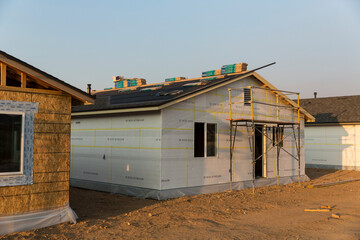 Unfinished housing with roofing shingles ready to be installed on top