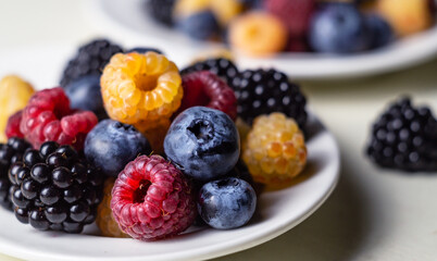Assorted fresh berries on a white plate