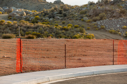 Orange Safety Fence Lines A Lot Near Desert Hill