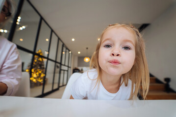 Fototapeta premium Adorable little girl looking at the camera close-up