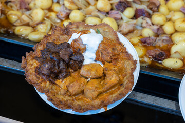 pork with potatoes in christmas market of Budapest