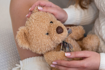 Soft toy bear in the hands of a girl © Natalia