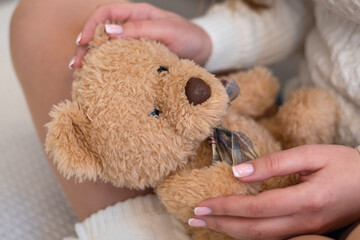 Soft toy bear in the hands of a girl