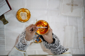 A priest celebrates a mass and consecrates wine and bread 