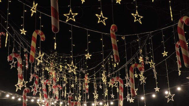 Hanging decorative elements for a Christmas party, light, lolipops, decoration for winter holidays outside.
