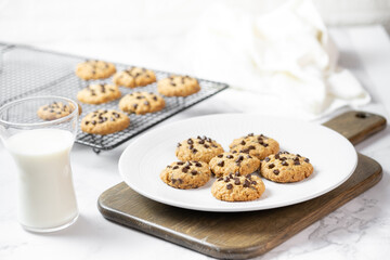 Delicious Whole Wheat Chocolate Chip Cookies set on white cafe table.