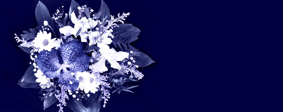 Trendy bouquet with flower of blue classic color on black background. Copy space