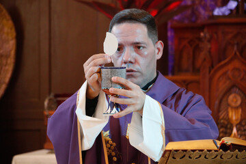 a priest celebrates a mass in lent 