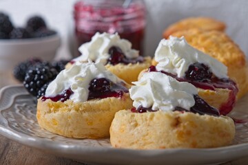 Scones with homemade blackberry jam, cream and fresh blackberries