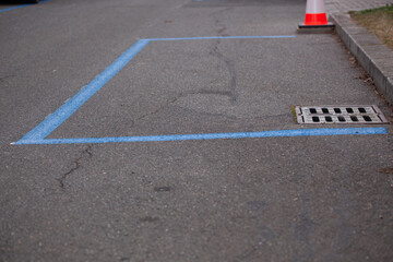 Blue zone on the asphalt road. A regulated parking area delimited by blue bands on the street in Prague 5.