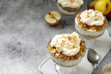 Apple trifle in a glass bowl on a light culinary background. Traditional Scandinavian aebletrifli on the kitchen table	