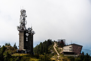 Telecommunication tower, radio relay and Black goat cable car (Telecabina Capra Neagra), Postavaru peak, Poiana Brasov, Romania.