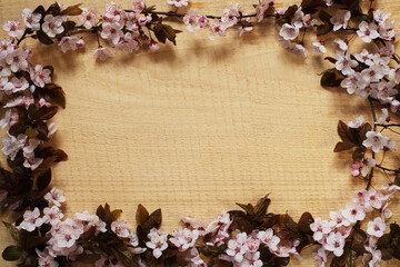 Blooming apricot twigs and a warm wooden background.