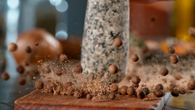 Freeze motion of crushing allspice balls with mortar pestle