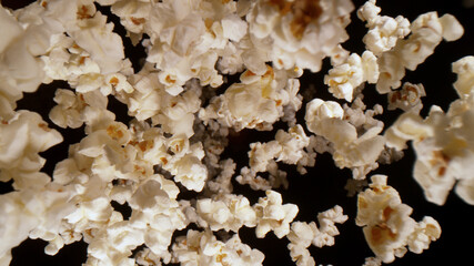 Macro shot of falling popcorn on black background