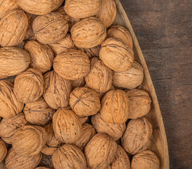 Walnuts on dark vintage table. Walnuts kernels with green leaves. Copyspace.