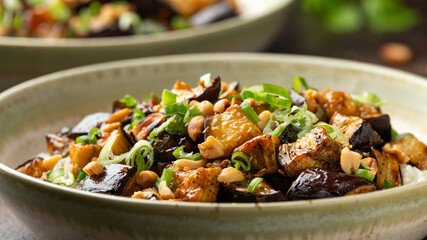 Asian Eggplant with rice, peanuts and spring onion. Healthy food.