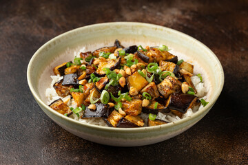 Asian Eggplant with rice, peanuts and spring onion. Healthy food.