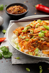 Korean Stir Fried pork belly kimchi with rice and spring onion. Asian food style