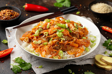 Korean Stir Fried pork belly kimchi with rice and spring onion. Asian food style